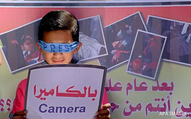 A Palestinian child take parts in a protest in support with the photographer, Mohammed Osman, in front of UNRWA headquarters in Gaza city on May 16, 2012. Photo by Ashraf Amra