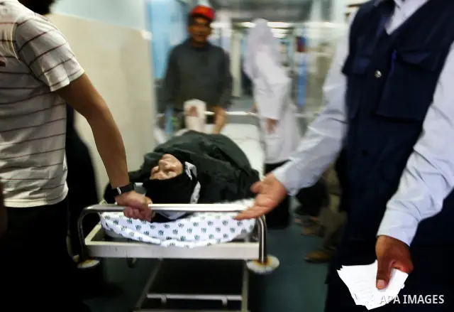 Palestinian medics receive a wounded man for treatment at a hospital in Gaza City on May 17, 2012, following Israeli shelling into the Gaza Strip in which seven people were wounded, two of them in critical condition, nea...