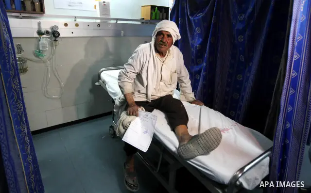 Palestinian medics receive a wounded man for treatment at a hospital in Gaza City on May 17, 2012, following Israeli shelling into the Gaza Strip in which seven people were wounded, two of them in critical condition, nea...