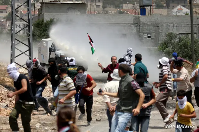 Israeli truck spray foul smelling water towards Palestinians during clashes in the northern West Bank village of Kufr Qaddum, near the Jewish settlement of Kdumim, Friday, May 18, 2012. Photo by Wagdi Eshtayah
