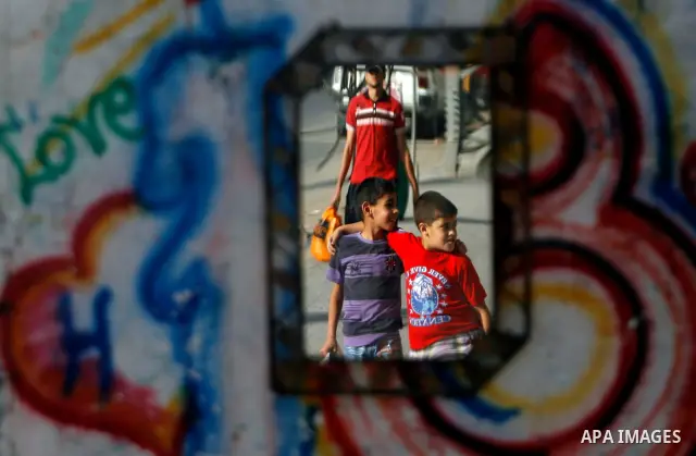 Palestinian children play, near smuggling tunnels on the border between Egypt and Gaza in the southern Gaza Strip at the Rafah Refugee Camp on May 19, 2012. Living conditions in Gaza have deteriorated because of Israeli...