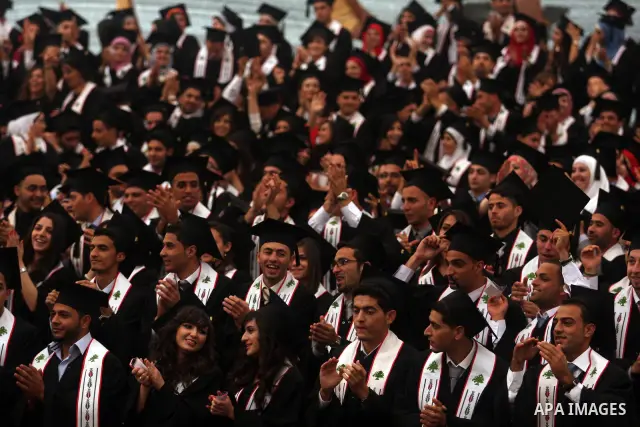 Palestinian students attend their graduation ceremony at the Birzeit University near the West Bank city of Ramallah. as some 3000 students received their degrees at the end of the academic year on May 19, 2012. Photo by...