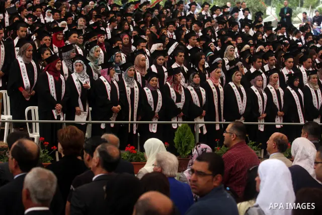 Palestinian students attend their graduation ceremony at the Birzeit University near the West Bank city of Ramallah. as some 3000 students received their degrees at the end of the academic year on May 19, 2012. Photo by...