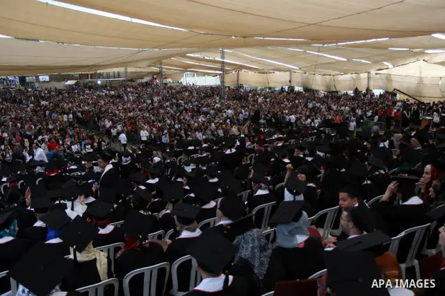 Palestinian students attend their graduation ceremony at the Birzeit University near the West Bank city of Ramallah. as some 3000 students received their degrees at the end of the academic year on May 19, 2012. Photo by...