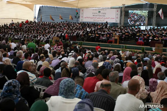 Palestinian students attend their graduation ceremony at the Birzeit University near the West Bank city of Ramallah. as some 3000 students received their degrees at the end of the academic year on May 19, 2012. Photo by...