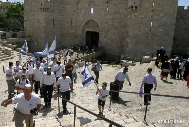 Israelis march and dance in the old city of Jerusalem on May 20, 2012 during Jerusalem Day celebrations marking the Jewish state's capture of the Arab eastern sector 45 years ago during the Six-Day War. Photo by Mahfouz...