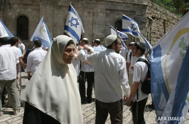Israelis march and dance in the old city of Jerusalem on May 20, 2012 during Jerusalem Day celebrations marking the Jewish state's capture of the Arab eastern sector 45 years ago during the Six-Day War. Photo by Mahfouz...