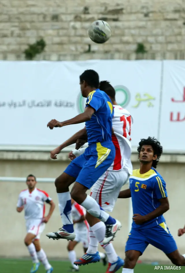 Tunisia and Sri Lanka footballers fight for possession during a football match. Tunisia and Sri Lanka footballers face-off during the Nakba Championship in the West Bank city of Nablus, on May 20, 2012. Nakba for the Pal...