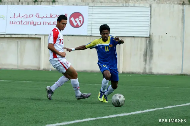 Tunisia and Sri Lanka footballers fight for possession during a football match. Tunisia and Sri Lanka footballers face-off during the Nakba Championship in the West Bank city of Nablus, on May 20, 2012. Nakba for the Pal...