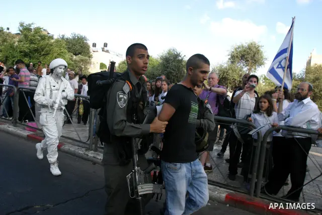 Israeli policemen detain a Palestinian demonstrator protesting against a parade marking Jerusalem Day in front of Damascus Gate outside Jerusalem's Old City on May 20, 2012. Israel occupied East Jerusalem in the 1967 Mid...