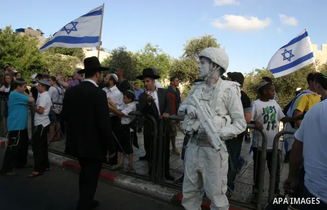 Israeli performance artists rest during a parade marking Jerusalem Day in Jerusalem's Old City May 20, 2012. Jerusalem Day marks the anniversary of Israel's capture of the Eastern part of the city during the 1967 Middle...