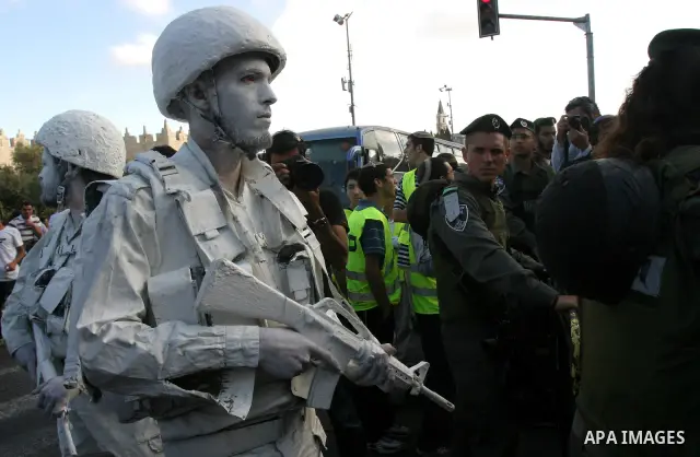 Israeli performance artists rest during a parade marking Jerusalem Day in Jerusalem's Old City May 20, 2012. Jerusalem Day marks the anniversary of Israel's capture of the Eastern part of the city during the 1967 Middle...