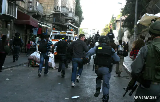 Israelis march and dance in the old city of Jerusalem on May 20, 2012 during Jerusalem Day celebrations marking the Jewish state's capture of the Arab eastern sector 45 years ago during the Six-Day War. Photo by Mahfouz...