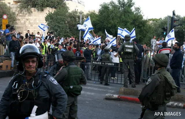 Israelis march and dance in the old city of Jerusalem on May 20, 2012 during Jerusalem Day celebrations marking the Jewish state's capture of the Arab eastern sector 45 years ago during the Six-Day War. Photo by Mahfouz...
