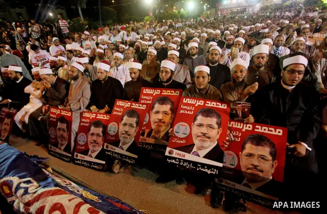 Supporters of the Muslim Brotherhood's presidential candidate Mohammed Mursi, unseen, hold a rally Cairo, Egypt, Sunday, May 20, 2012. Egypt's election commission is vowing that next week's presidential election will be...