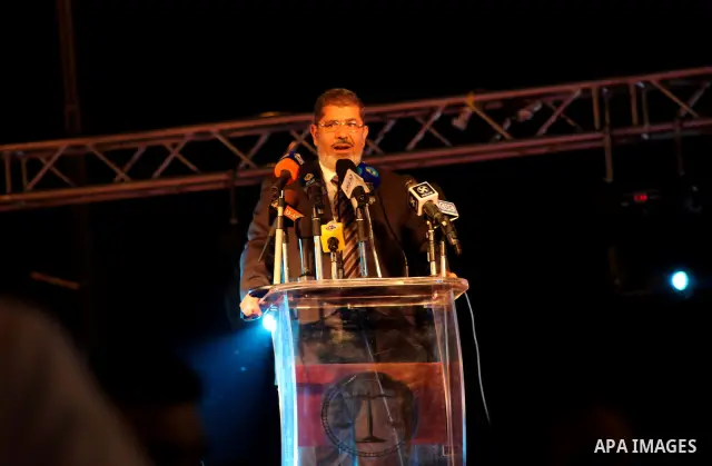 Mohamed Mursi, head of the Muslim Brotherhood's political party and the Brotherhood's presidential candidate, speaks during his last campaign rally in front of the Abdeen Palace Museum in Cairo May 20, 2012. Mursi has ca...