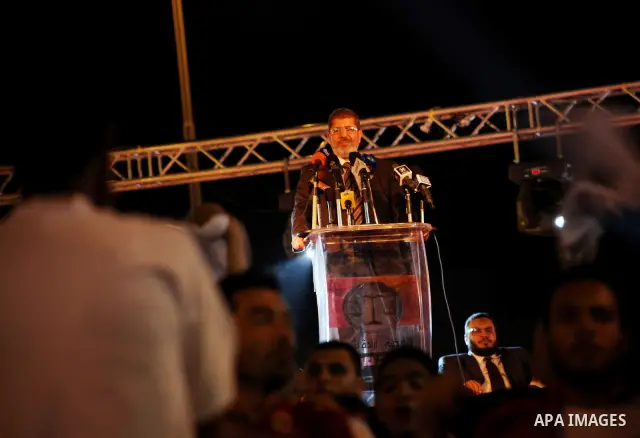Mohamed Mursi, head of the Muslim Brotherhood's political party and the Brotherhood's presidential candidate, speaks during his last campaign rally in front of the Abdeen Palace Museum in Cairo May 20, 2012. Mursi has ca...
