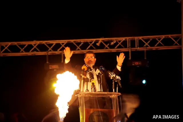 Mohamed Mursi, head of the Muslim Brotherhood's political party and the Brotherhood's presidential candidate, speaks during his last campaign rally in front of the Abdeen Palace Museum in Cairo May 20, 2012. Mursi has ca...