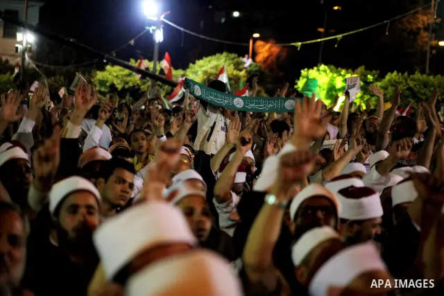Supporters of the Muslim Brotherhood's presidential candidate Mohammed Mursi, unseen, hold a rally Cairo, Egypt, Sunday, May 20, 2012. Egypt's election commission is vowing that next week's presidential election will be...