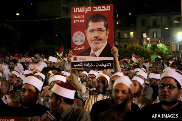 Supporters of the Muslim Brotherhood's presidential candidate Mohammed Mursi, unseen, hold a rally Cairo, Egypt, Sunday, May 20, 2012. Egypt's election commission is vowing that next week's presidential election will be...