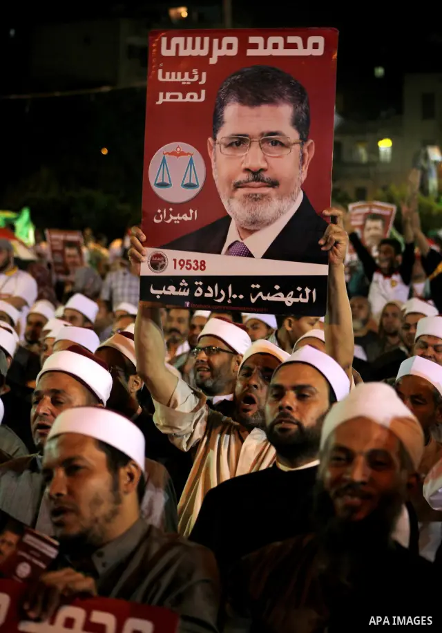 Supporters of the Muslim Brotherhood's presidential candidate Mohammed Mursi, unseen, hold a rally Cairo, Egypt, Sunday, May 20, 2012. Egypt's election commission is vowing that next week's presidential election will be...