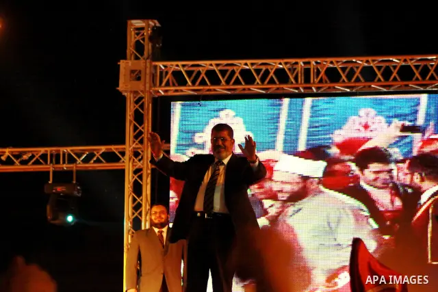 Mohamed Mursi, head of the Muslim Brotherhood's political party and the Brotherhood's presidential candidate, attends during his last campaign rally in front of the Abdeen Palace Museum in Cairo May 20, 2012. Mursi has c...