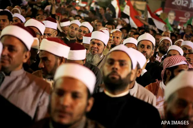 Supporters of the Muslim Brotherhood's presidential candidate Mohammed Mursi, unseen, hold a rally Cairo, Egypt, Sunday, May 20, 2012. Egypt's election commission is vowing that next week's presidential election will be...