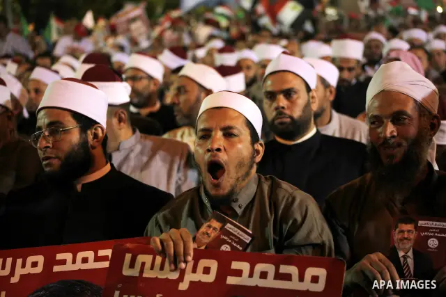 Supporters of the Muslim Brotherhood's presidential candidate Mohammed Mursi, unseen, hold a rally Cairo, Egypt, Sunday, May 20, 2012. Egypt's election commission is vowing that next week's presidential election will be...