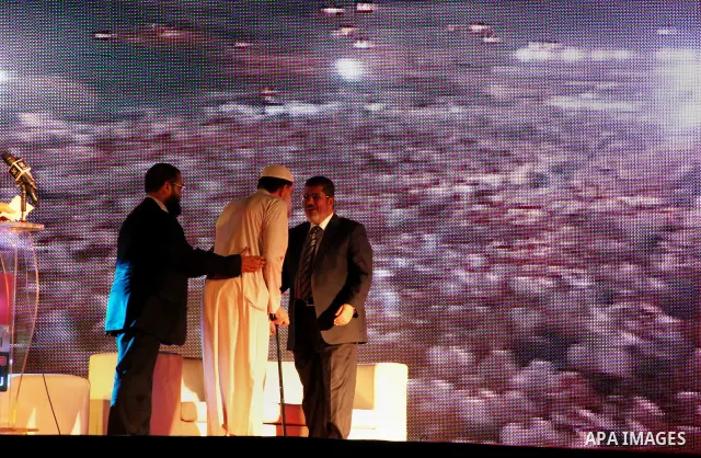Mohamed Mursi, head of the Muslim Brotherhood's political party and the Brotherhood's presidential candidate, attends during his last campaign rally in front of the Abdeen Palace Museum in Cairo May 20, 2012. Mursi has c...