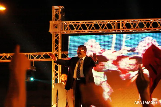 Mohamed Mursi, head of the Muslim Brotherhood's political party and the Brotherhood's presidential candidate, attends during his last campaign rally in front of the Abdeen Palace Museum in Cairo May 20, 2012. Mursi has c...