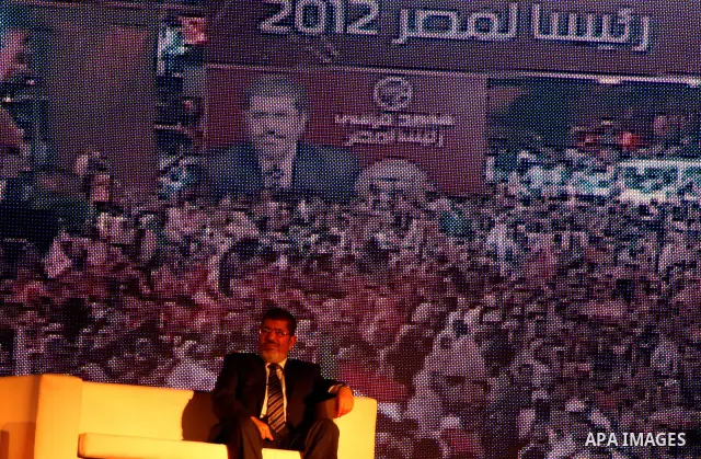 Mohamed Mursi, head of the Muslim Brotherhood's political party and the Brotherhood's presidential candidate, attends during his last campaign rally in front of the Abdeen Palace Museum in Cairo May 20, 2012. Mursi has c...