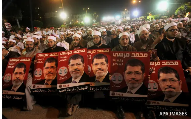 Supporters of the Muslim Brotherhood's presidential candidate Mohammed Mursi, unseen, hold a rally Cairo, Egypt, Sunday, May 20, 2012. Egypt's election commission is vowing that next week's presidential election will be...