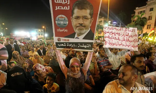 Supporters of the Muslim Brotherhood's presidential candidate Mohammed Mursi, unseen, hold a rally Cairo, Egypt, Sunday, May 20, 2012. Egypt's election commission is vowing that next week's presidential election will be...