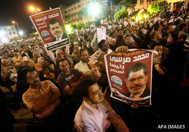 Supporters of the Muslim Brotherhood's presidential candidate Mohammed Mursi, unseen, hold a rally Cairo, Egypt, Sunday, May 20, 2012. Egypt's election commission is vowing that next week's presidential election will be...