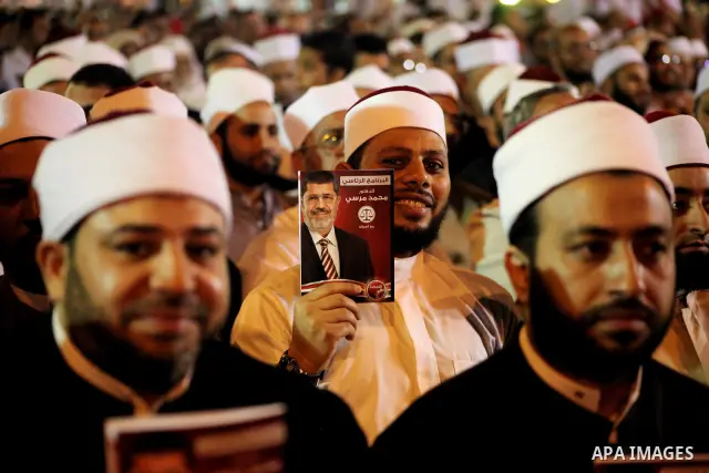 Supporters of the Muslim Brotherhood's presidential candidate Mohammed Mursi, unseen, hold a rally Cairo, Egypt, Sunday, May 20, 2012. Egypt's election commission is vowing that next week's presidential election will be...