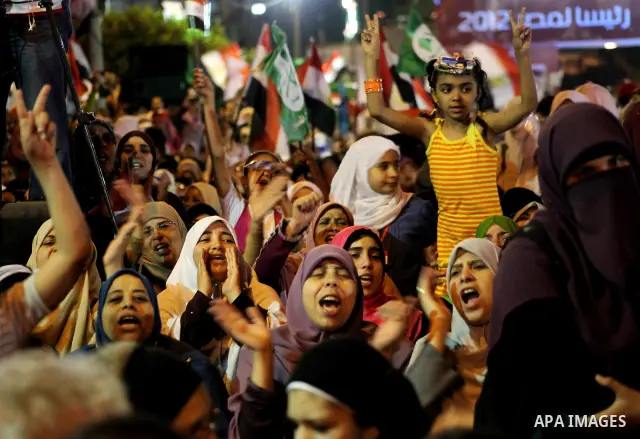 Supporters of the Muslim Brotherhood's presidential candidate Mohammed Mursi, unseen, hold a rally Cairo, Egypt, Sunday, May 20, 2012. Egypt's election commission is vowing that next week's presidential election will be...