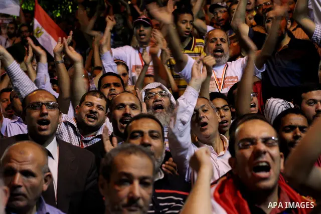 Supporters of the Muslim Brotherhood's presidential candidate Mohammed Mursi, unseen, hold a rally Cairo, Egypt, Sunday, May 20, 2012. Egypt's election commission is vowing that next week's presidential election will be...