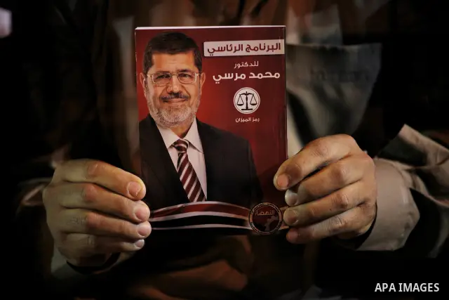 Supporters of the Muslim Brotherhood's presidential candidate Mohammed Mursi, unseen, hold a rally Cairo, Egypt, Sunday, May 20, 2012. Egypt's election commission is vowing that next week's presidential election will be...