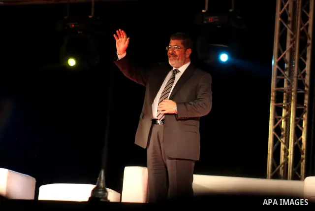 Mohamed Mursi, head of the Muslim Brotherhood's political party and the Brotherhood's presidential candidate, attends during his last campaign rally in front of the Abdeen Palace Museum in Cairo May 20, 2012. Mursi has c...