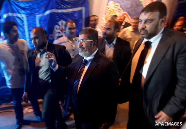 Mohamed Mursi, head of the Muslim Brotherhood's political party and the Brotherhood's presidential candidate, attends during his last campaign rally in front of the Abdeen Palace Museum in Cairo May 20, 2012. Mursi has c...
