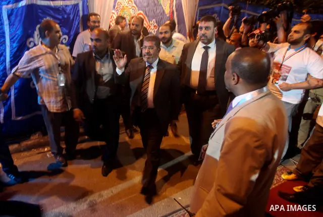 Mohamed Mursi, head of the Muslim Brotherhood's political party and the Brotherhood's presidential candidate, attends during his last campaign rally in front of the Abdeen Palace Museum in Cairo May 20, 2012. Mursi has c...