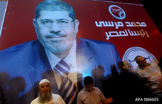 Supporters of the Muslim Brotherhood's presidential candidate Mohammed Mursi, unseen, hold a rally Cairo, Egypt, Sunday, May 20, 2012. Egypt's election commission is vowing that next week's presidential election will be...