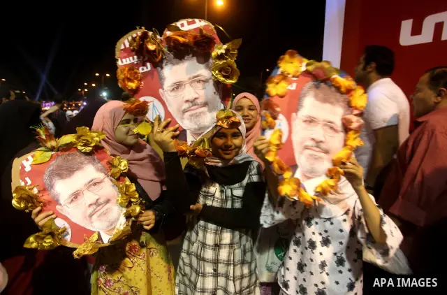 Supporters of the Muslim Brotherhood's presidential candidate Mohammed Mursi, unseen, hold a rally Cairo, Egypt, Sunday, May 20, 2012. Egypt's election commission is vowing that next week's presidential election will be...