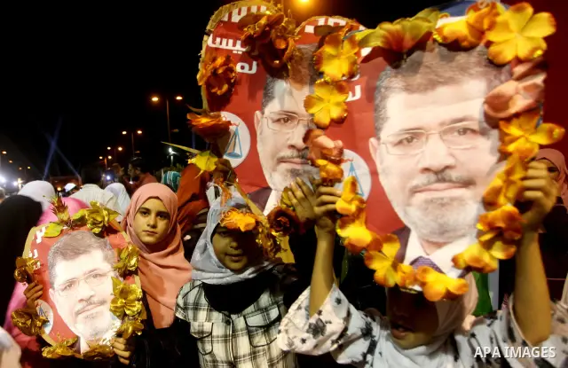 Supporters of the Muslim Brotherhood's presidential candidate Mohammed Mursi, unseen, hold a rally Cairo, Egypt, Sunday, May 20, 2012. Egypt's election commission is vowing that next week's presidential election will be...