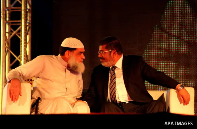 Mohamed Mursi, head of the Muslim Brotherhood's political party and the Brotherhood's presidential candidate, attends during his last campaign rally in front of the Abdeen Palace Museum in Cairo May 20, 2012. Mursi has c...