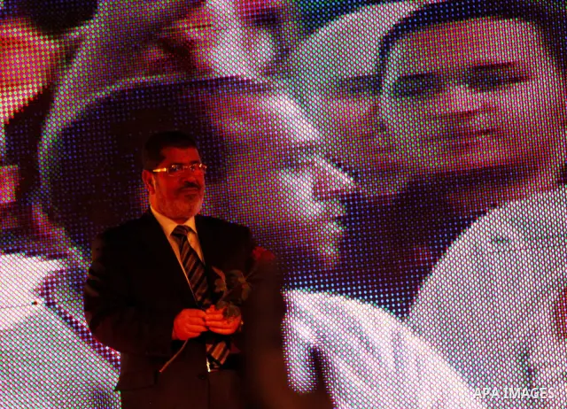 Mohamed Mursi, head of the Muslim Brotherhood's political party and the Brotherhood's presidential candidate, attends during his last campaign rally in front of the Abdeen Palace Museum in Cairo May 20, 2012. Mursi has c...
