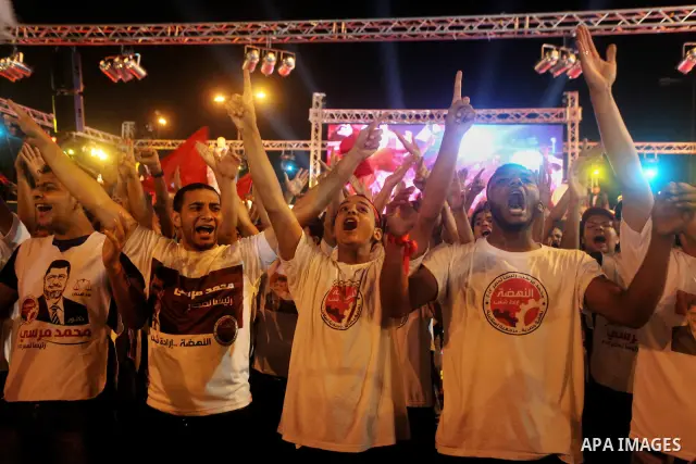 Supporters of the Muslim Brotherhood's presidential candidate Mohammed Mursi, unseen, hold a rally Cairo, Egypt, Sunday, May 20, 2012. Egypt's election commission is vowing that next week's presidential election will be...