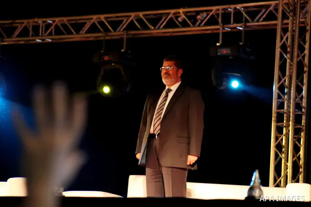 Mohamed Mursi, head of the Muslim Brotherhood's political party and the Brotherhood's presidential candidate, attends during his last campaign rally in front of the Abdeen Palace Museum in Cairo May 20, 2012. Mursi has c...