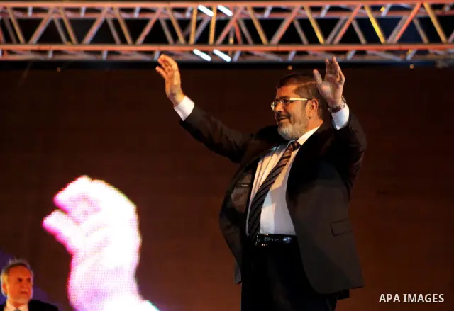 Mohamed Mursi, head of the Muslim Brotherhood's political party and the Brotherhood's presidential candidate, speaks during his last campaign rally in front of the Abdeen Palace Museum in Cairo May 20, 2012. Mursi has ca...