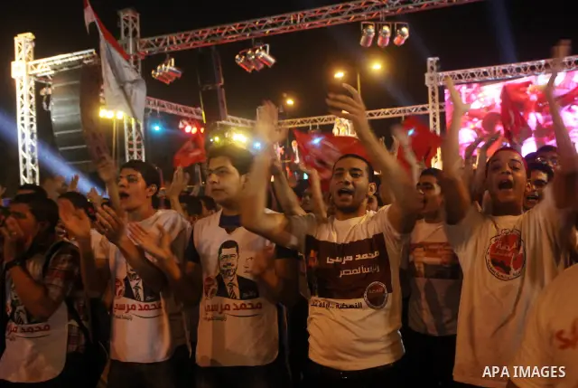 Supporters of the Muslim Brotherhood's presidential candidate Mohammed Mursi, unseen, hold a rally Cairo, Egypt, Sunday, May 20, 2012. Egypt's election commission is vowing that next week's presidential election will be...
